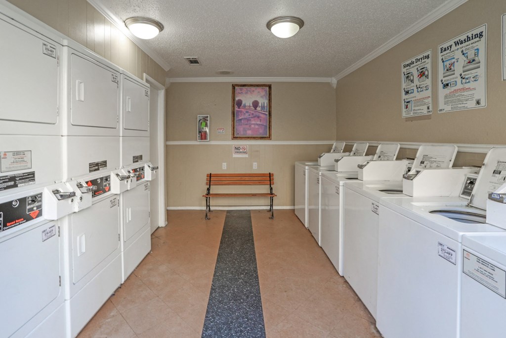 Onsite laundromat with rows of washers and dryers at Stone Canyon apartments in Shreveport, LA.