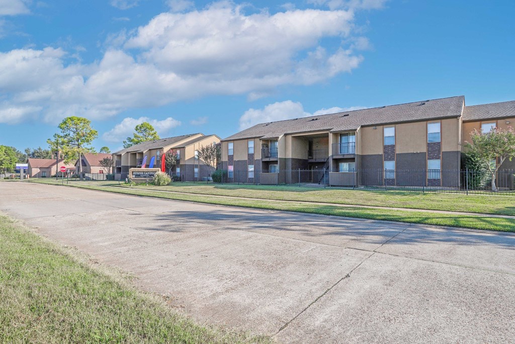 A row of apartment buildings with a clear blue sky above at Stone Canyon apartments in Shreveport, LA.