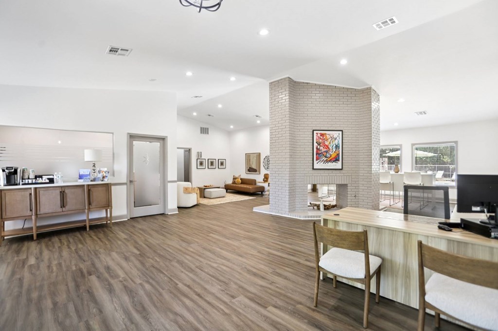 A spacious office with a desk, chairs, and a computer.