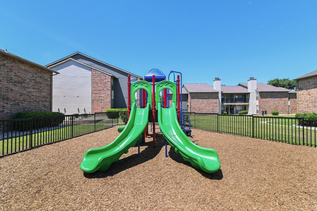 a playground at the whispering winds apartments in pearland, tx