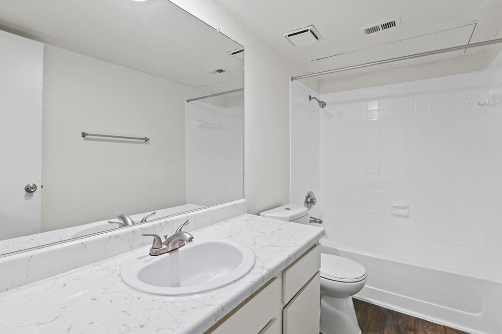 a bathroom with a sink toilet and shower