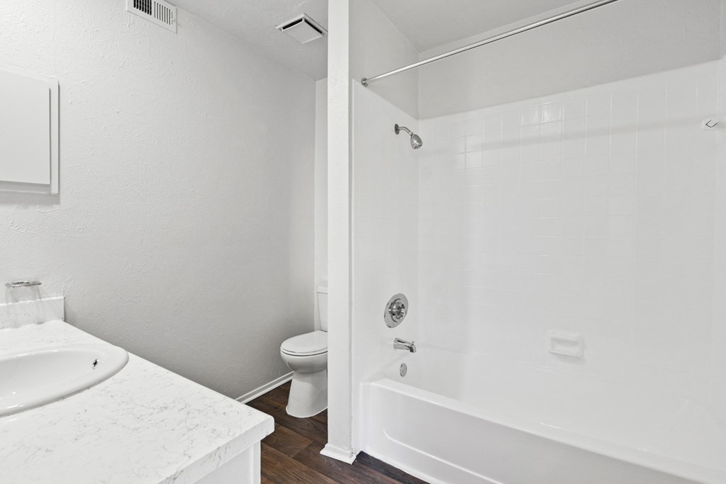 a bathroom with a toilet sink and shower