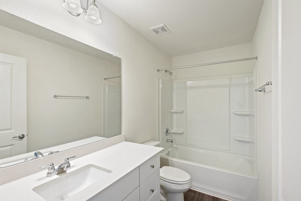 a bathroom with a bathtub and a sink