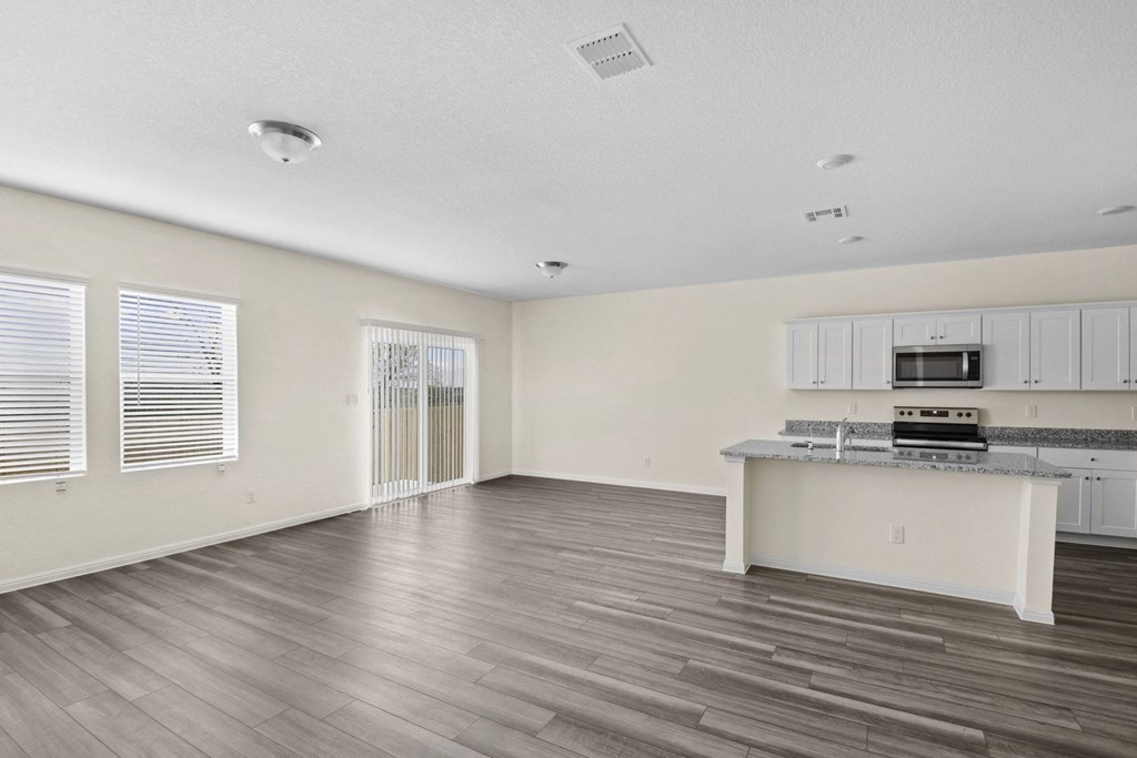 living room with big windows and white cabinets