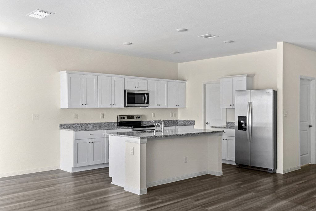 a kitchen with an island and stainless steel appliances