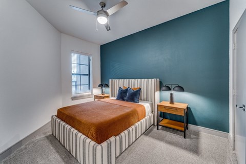 a bedroom with a bed and a ceiling fan