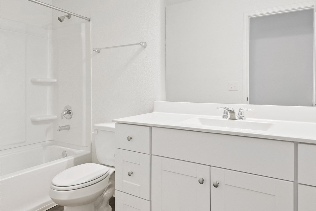 Sycamore bathroom with a white vanity and spacious shower/tub