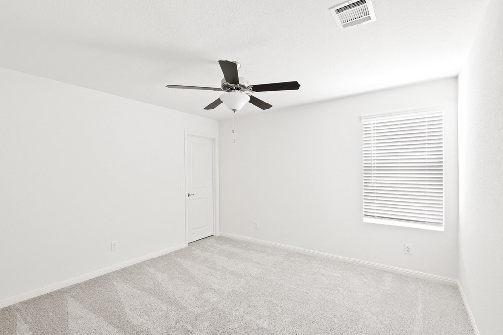 Sycamore spacious bedroom with ceiling fan and natural lighting at Beacon at Ashley River Landing in Summerville, SC
