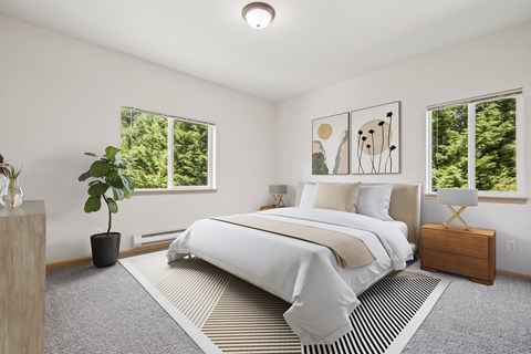 Master bedroom virtually staged with a large bed and a potted plant in the Jackson floor plan at The Madison apartments in Olympia, WA