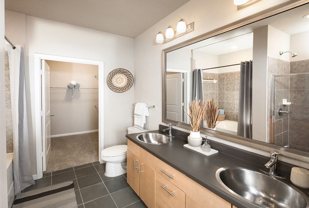 Bathroom with Double Vanity and Walk-In Closet at The Grand at Upper Kirby | Apartments in Houston, TX