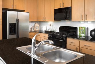 Kitchen with Granite Countertops at The Grand at Upper Kirby | Apartments in Houston, TX