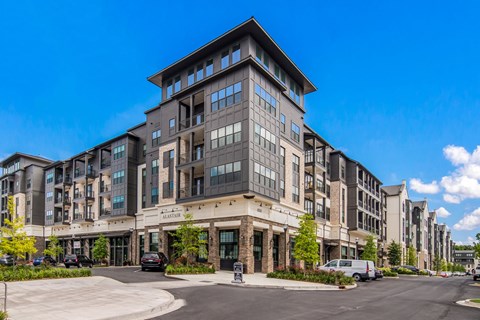 a large apartment building with cars parked in front of it