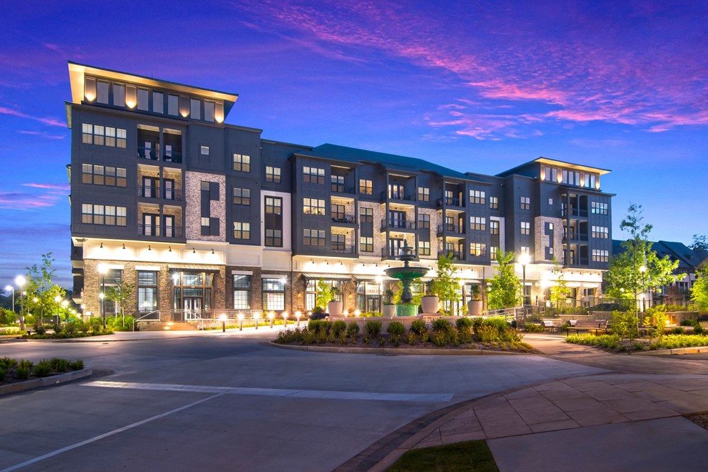 a night view of the building with lights on at The Alastair at Aria Village Apartment Homes in Sandy Springs, Georgia, GA