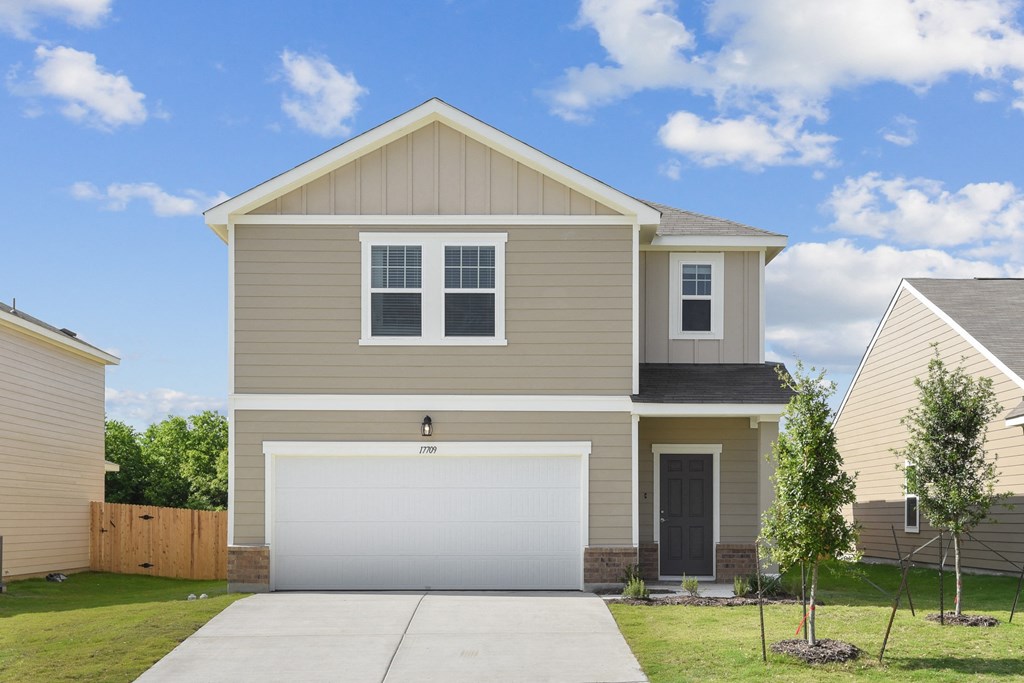 a house with a white garage door at Beacon at Vine Creek, Pflugerville, Texas