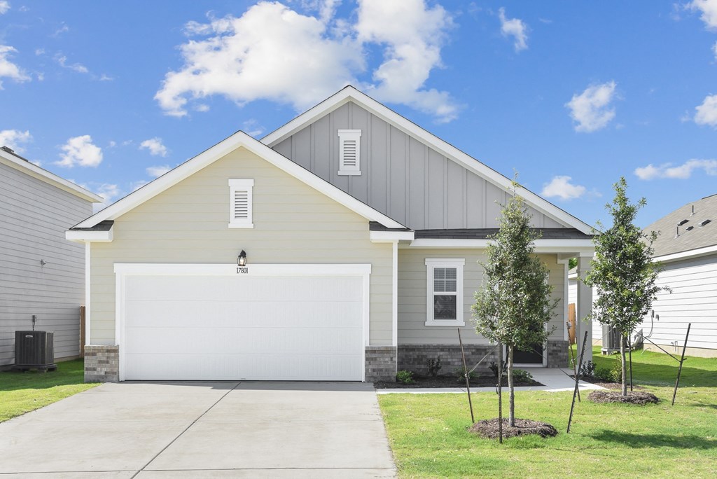 a home with a gray siding and a white garage door at Beacon at Vine Creek, Pflugerville, TX, 78660