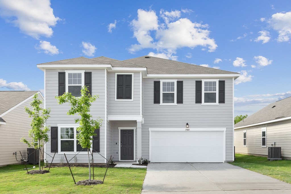 a house with a gray siding and black shutters at Beacon at Vine Creek, Texas, 78660