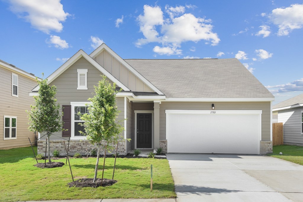 a house with a gray siding and a gray garage door at Beacon at Vine Creek, Pflugerville, 78660
