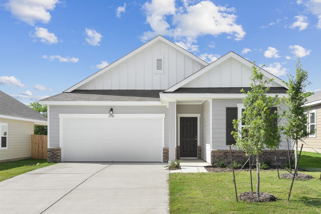 a house with a tree in the front yard  at Beacon at Vine Creek, Pflugerville, TX