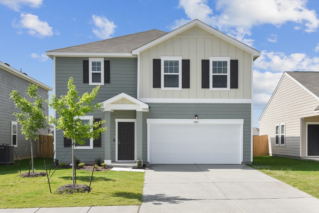 a house with a tree in the front yard at Beacon at Vine Creek, Pflugerville, TX, 78660