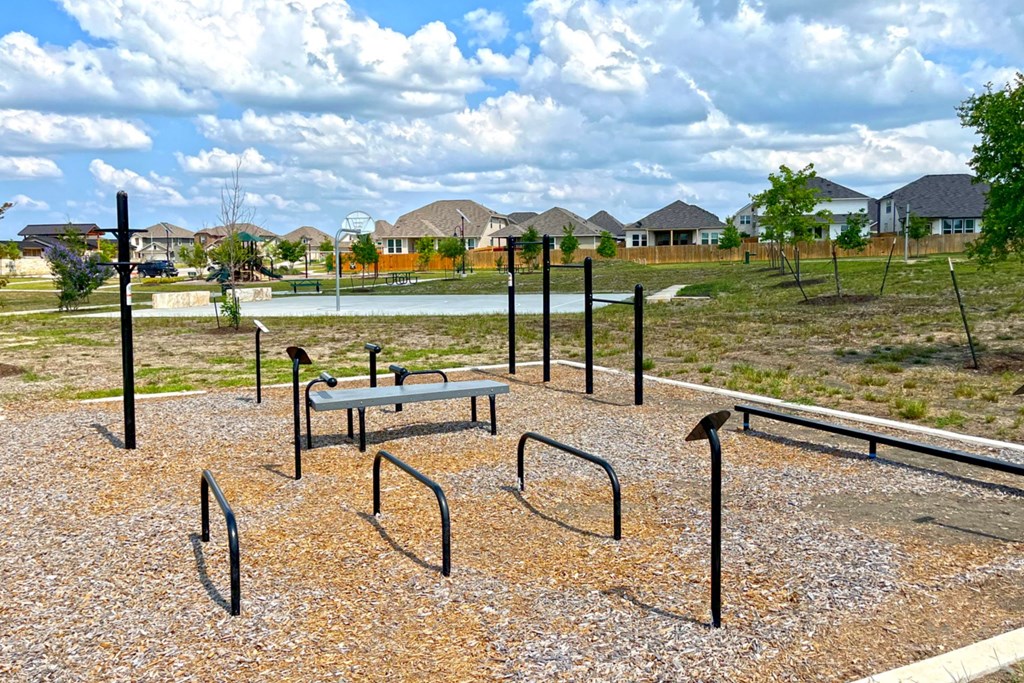 a park with a lake and houses in the background at Beacon at Vine Creek, Pflugerville, 78660