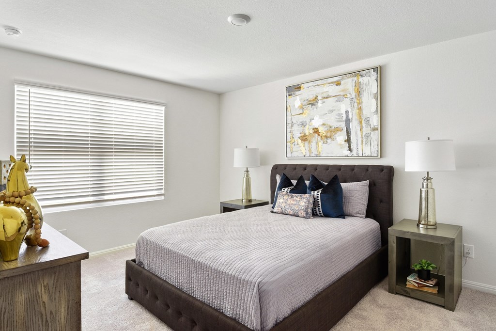 a bedroom with a large bed and a window with blinds at Beacon at Vine Creek, Texas, 78660