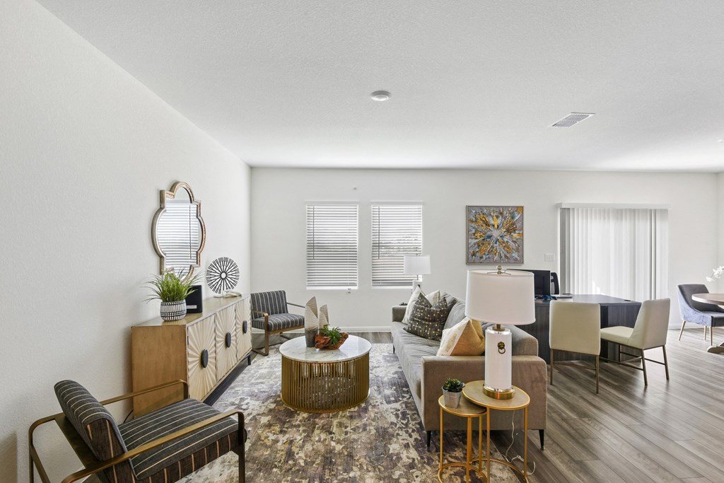 a living room with white walls and hardwood flooring at Beacon at Vine Creek, Texas