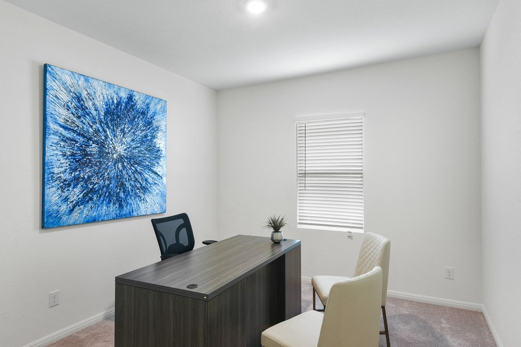 an office with a blue painting on the wall at Beacon at Vine Creek, Texas
