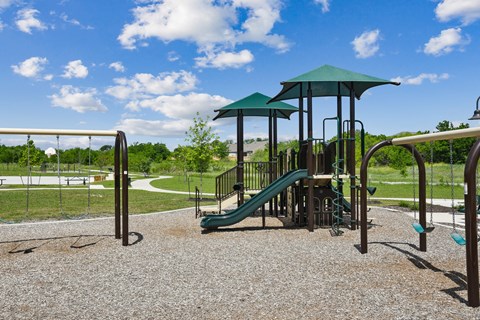 a playground with a slide and monkey bars at Beacon at Vine Creek, Texas