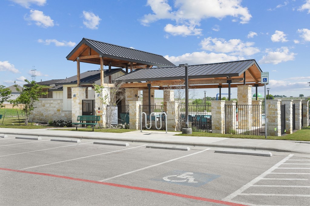 a bus stop with a fence and awning at Beacon at Vine Creek, Pflugerville, TX, 78660