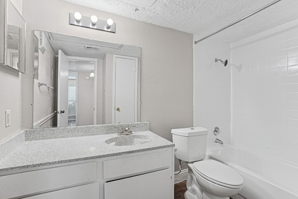 A1 bathroom with a sink, toilet, and bathtub at Vine Apartments in Arlington, TX
