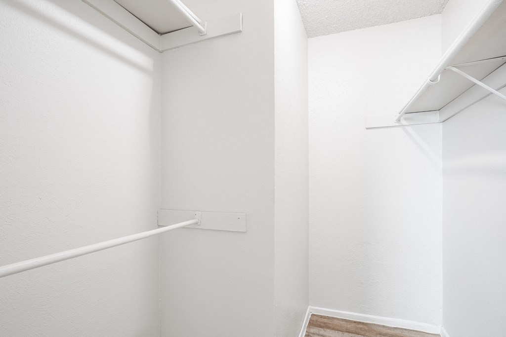 A1 white closet with a shelf and a vent at Vine Apartments in Arlington, TX