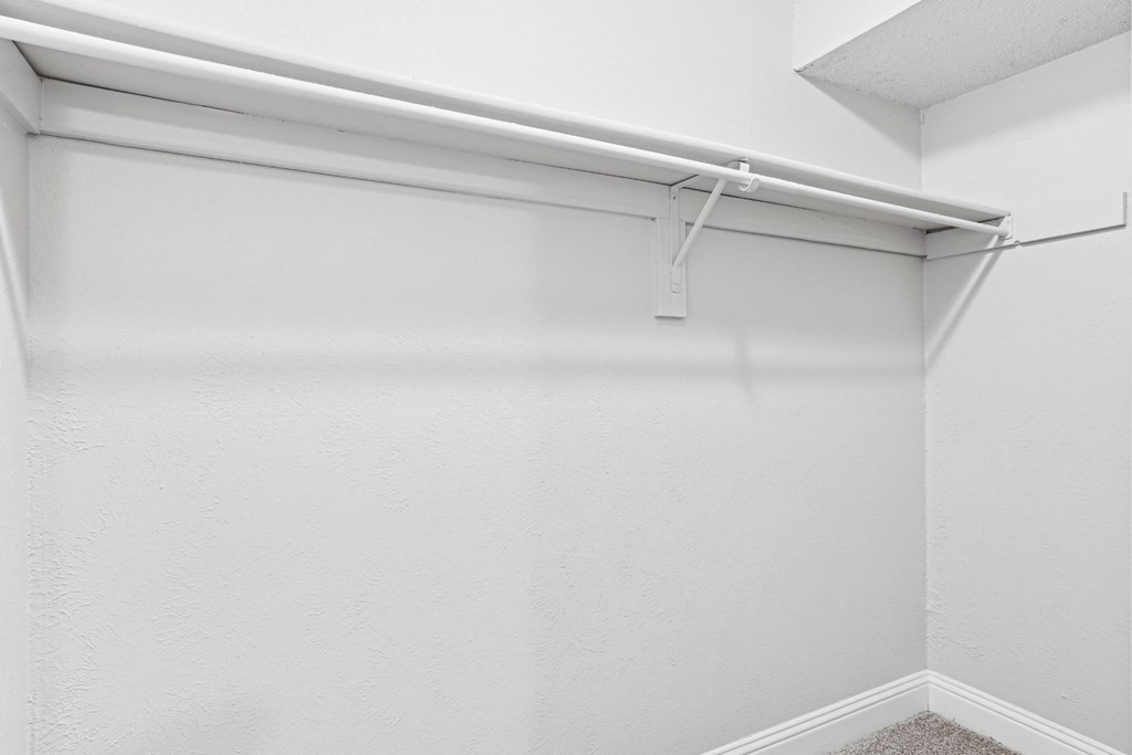 B1 closet with a white shelf and a white ceiling at Vine Apartments in Arlington, TX