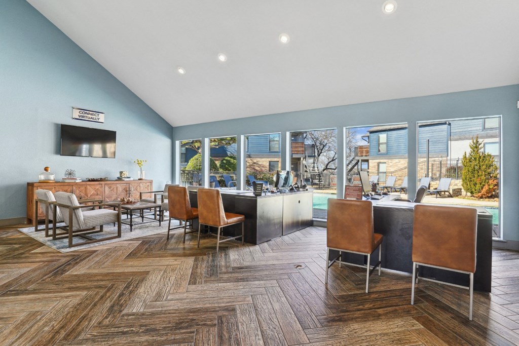 A leasing office with chairs and a counter at Vine Apartments in Arlington, TX
