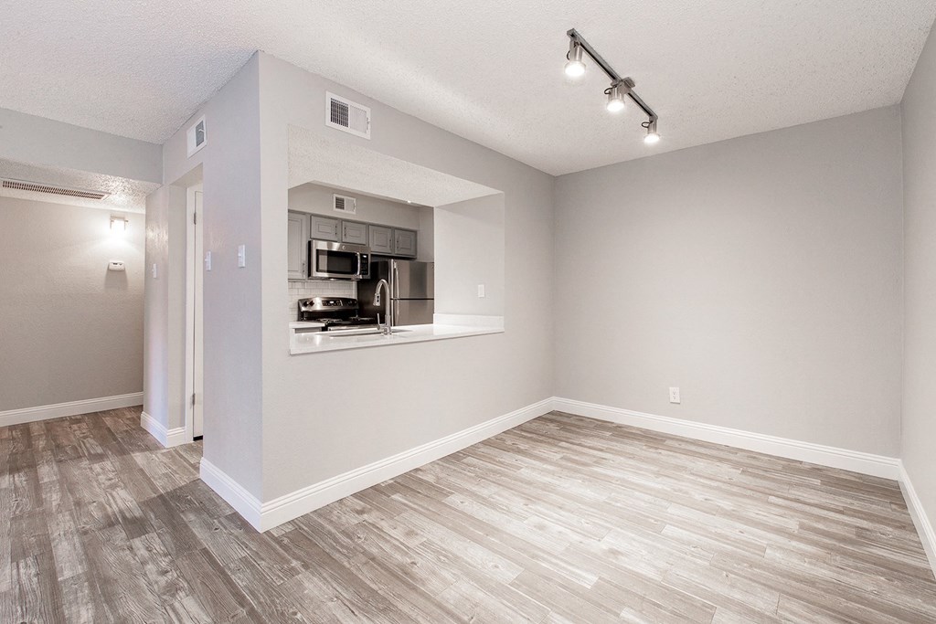 A2 upgraded kitchen and dining room with studio-style lighting at Vine Apartments in Arlington, TX