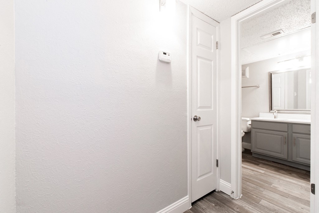 A2 upgraded apartment bathroom entrance with towel closet at Vine Apartments in Arlington, TX