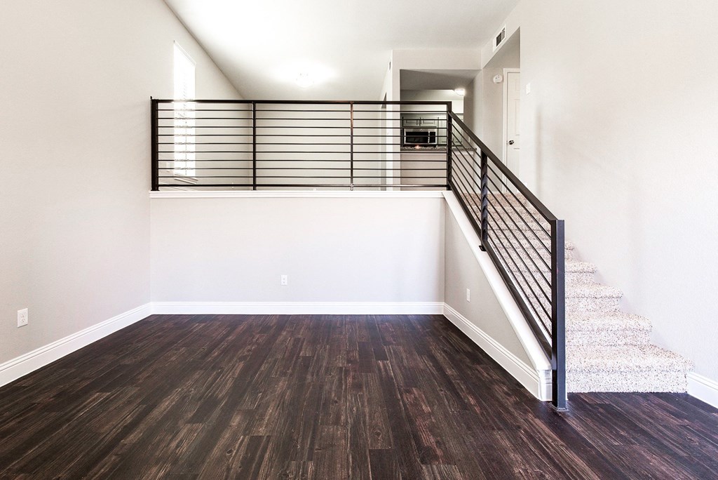 A4 living room  with staircase leading to a second floor where the kitchen and bedroom are at Vine Apartments in Arlington, TX