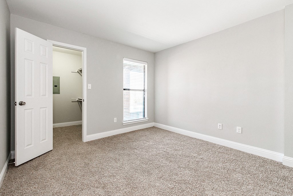 A4 apartment bedroom carpeted floor and walk-in closet at Vine Apartments in Arlington, TX