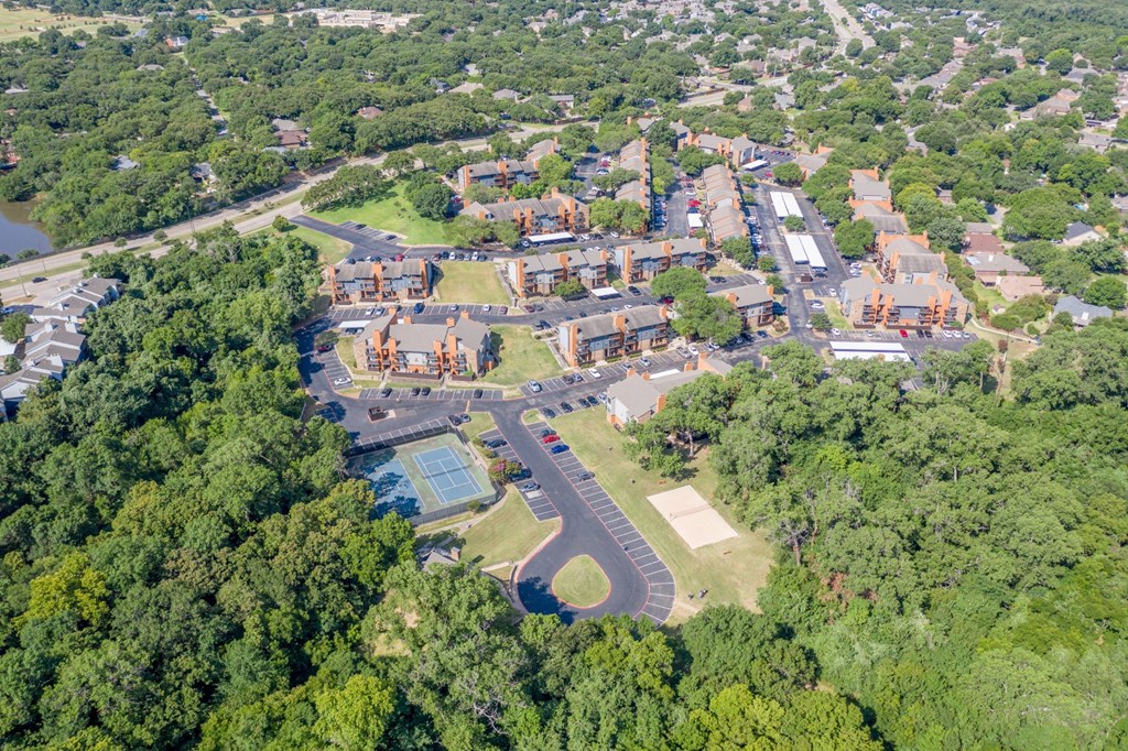 An aerial view of Vine Apartments surrounded by trees in Arlington, TX
