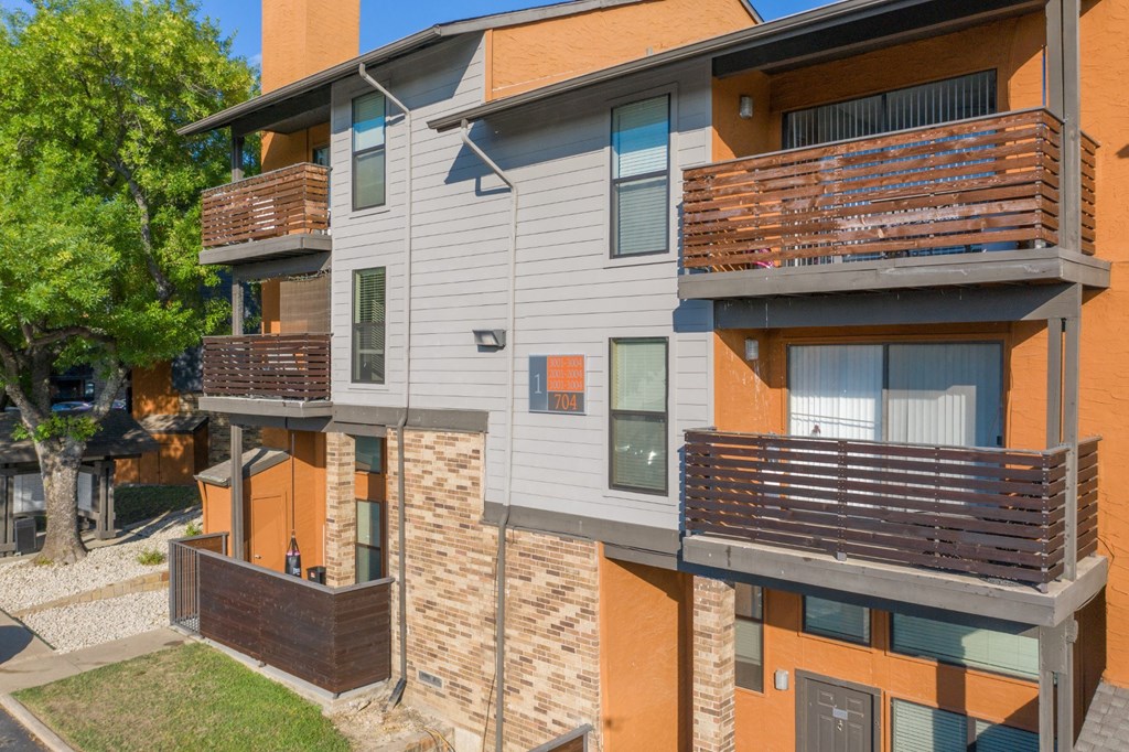 A modern apartment building with balconies at Vine Apartments in Arlington, TX