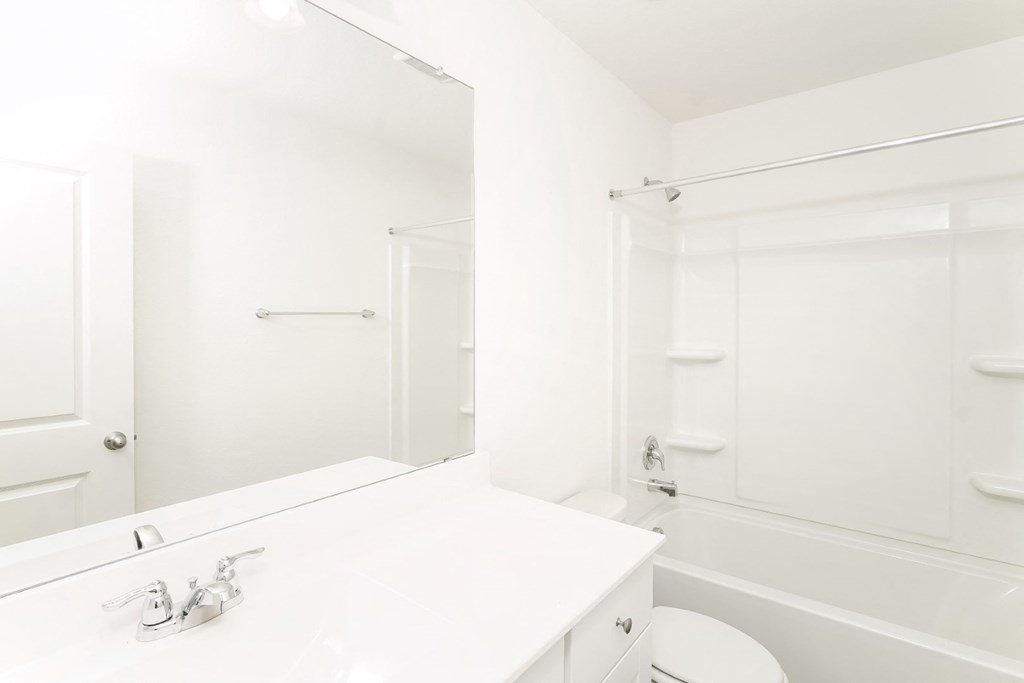 a bathroom with a bathtub and a sink