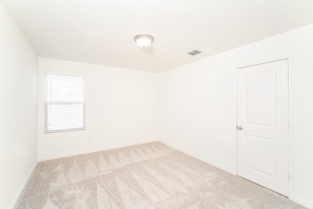 a bedroom with white walls and a white door at Beacon at Meridian, San Antonio, TX