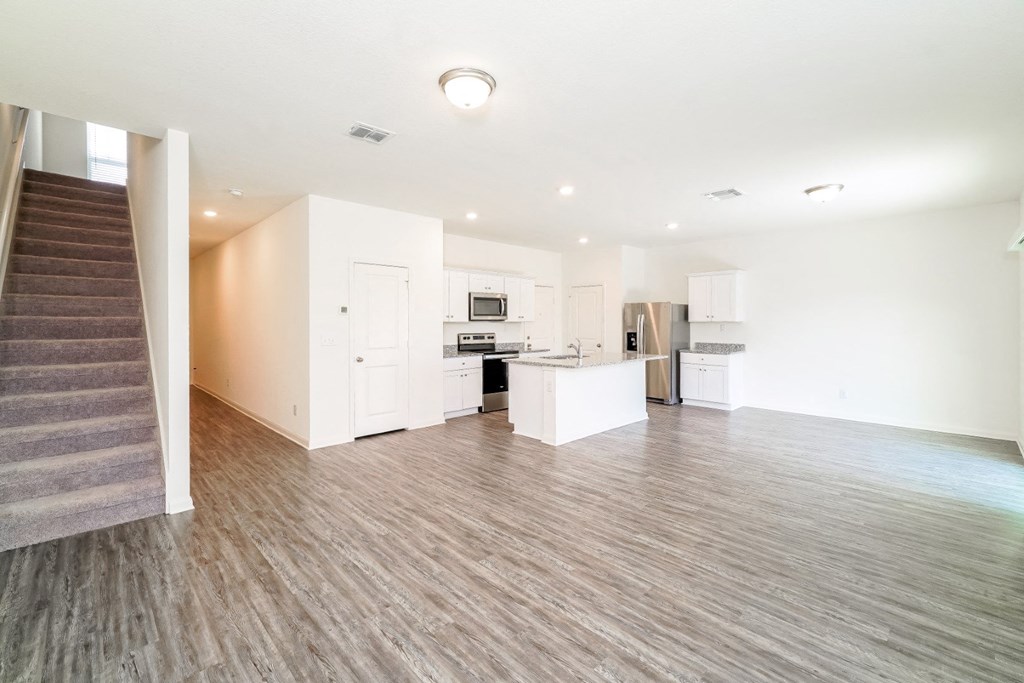 a kitchen and living room in an apartment