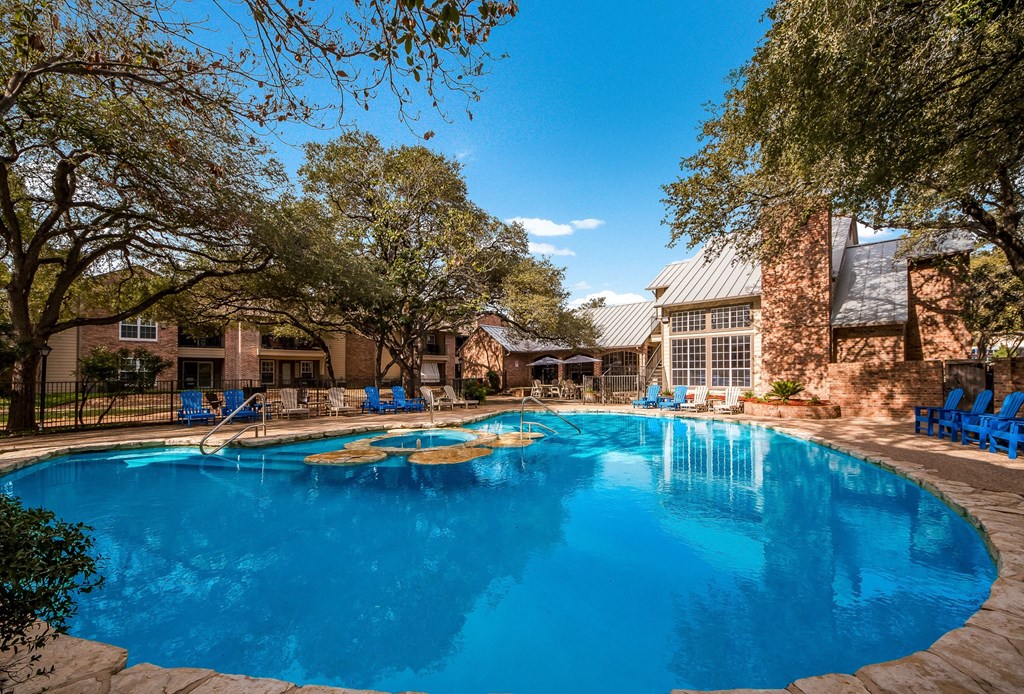 a large swimming pool with a building in the background