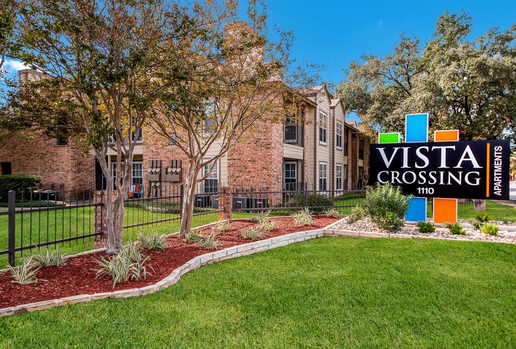 a view of the villa crossing apartment building with a sign that says visit crossing