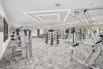a state of the art fitness center with treadmills and elliptical machines at Westgate on University in Lauderhill, FL