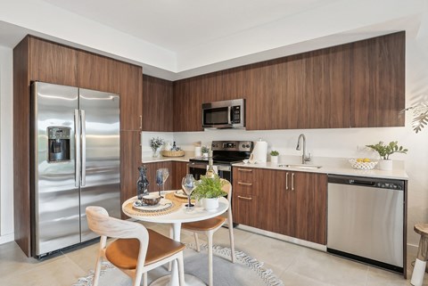 a kitchen with a table and two chairs at Westaget on Univeristy in Lauderhill, FL