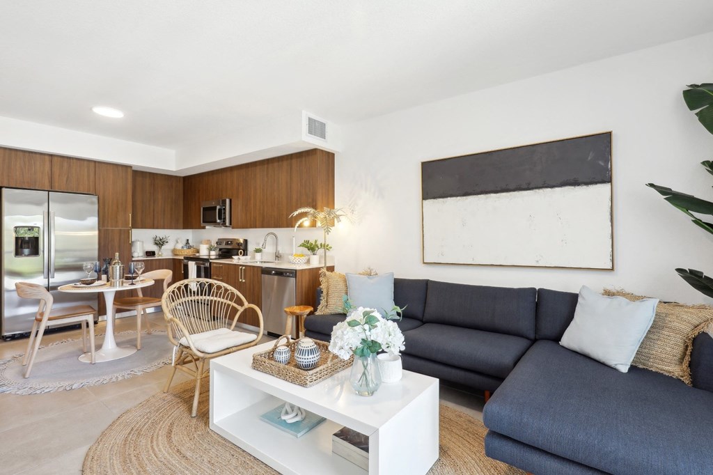 Living Room in A1 Floor Plan with L-Shaped Couch at Westgate on University in Lauderhill, FL