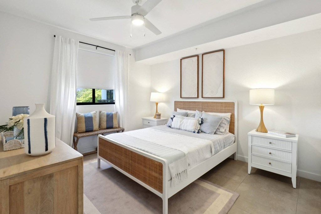 Bedroom 1 in B1 Floor Plan with large bed and nightstand at Westgate on University in Lauderhill, FL