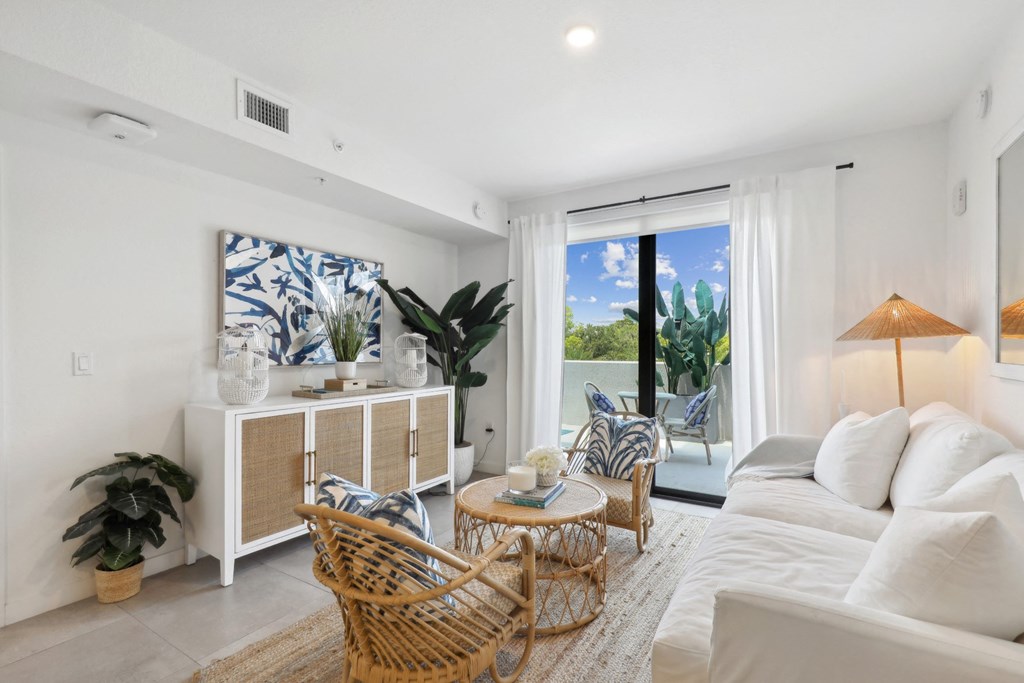 Living Room with entertainment center and white couch in B1 Floor Plan at Westgate on University in Lauderhill, FL