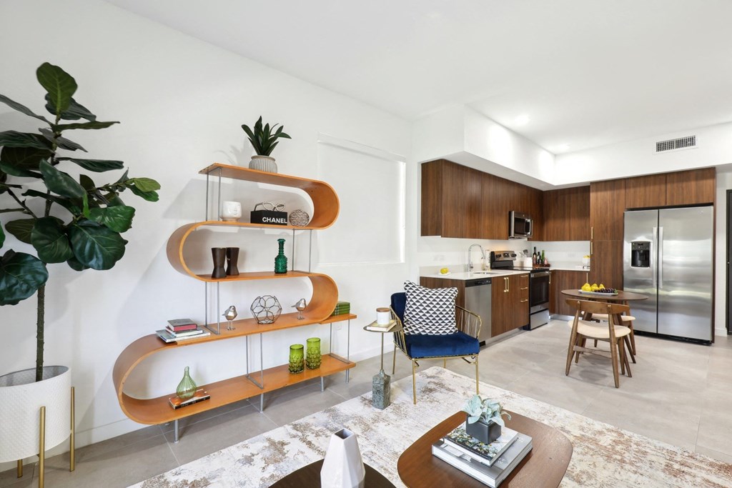 Living Room in A2 Floor Plan with wavy bookshelf at Westgate on University in Lauderhill, FL